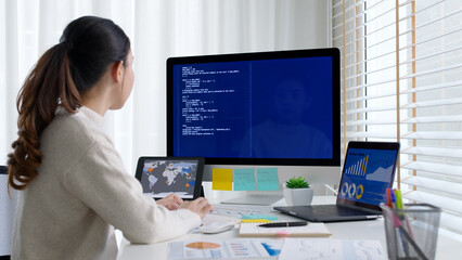 Asia young business woman sit busy at home office desk work code on desktop reskill upskill for job career remote self test IT deep tech ai design skill online html text for cyber security workforce.
