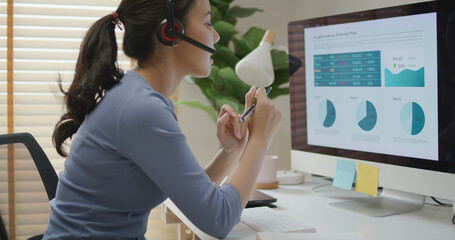 Asia people young casual woman remote work at desk home phone call talk study learn MBA online class. SEO sale plan report data chart graph on desktop PC screen reskill upskill career job workforce.