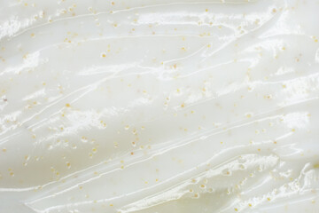 Texture of face scrub on yellow background.