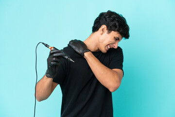 Tattoo artist Argentinian man isolated on blue background suffering from pain in shoulder for having made an effort