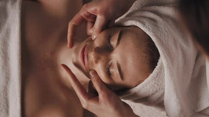 Beautician making facelifting massage at the beauty salon. Beautiful young girl. Body care. Cosmetic beauty spa salon. Beauty face. - Powered by Adobe