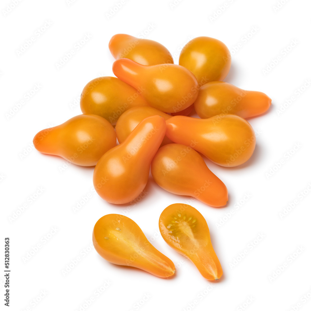 Sticker heap of yellow whole and halved pear tomatoes isolated on white background close up