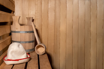 Fototapeta na wymiar Traditional old Russian bathhouse SPA Concept. Interior details Finnish sauna steam room with traditional sauna accessories set scoop felt. Relax country village bath concept