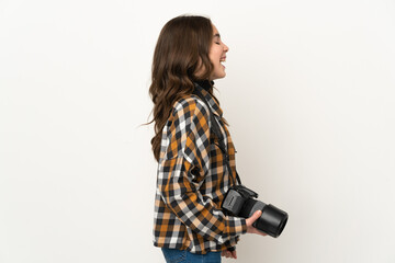 Little photographer girl isolated on background laughing in lateral position