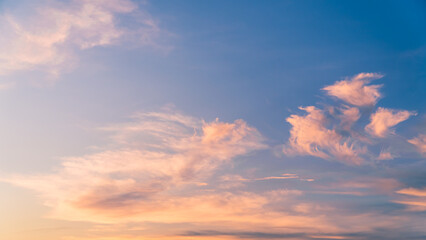 Evening sky with orange sunlight clouds on blue background