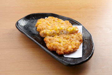 corn fish cake served in a dish isolated on wooden table background side view of singapore food