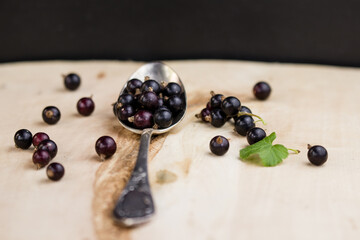 black currant berries on a spoon