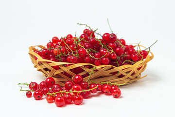 Redcurrant in a basket on a white background. Fresh ripe red currant. summer berry