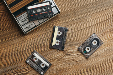 Compact cassette tapes and cassette recorder. Retro music style. 80s music party. Vintage style. Analog equipment. Stereo sound. Back to the past