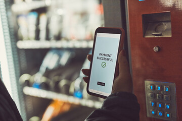 Consumer paying for product at vending machine using contactless method of payment with mobile...
