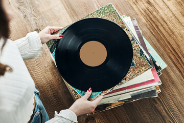 Playing vinyl records. Listening to music from vinyl record player. Retro and vintage music style....