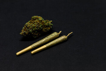 Dried flower marijuana and Pre-Rolls Cannabis Joints on a black background