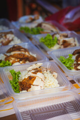 Typical Malaysian daily food at street stall or bazaar, Chicken Rice packed in bio degradable plastic container .