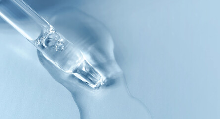 Pipette with fluid serum, oil, face gel cleaner. Cosmetics and healthcare concept closeup. Dose of...