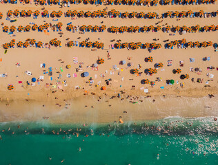 Fototapeta na wymiar Drone aerial of beach umbrellas in the beach. Summer holidays