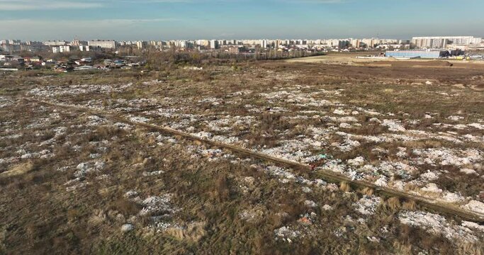 two people walking on a huge aste, garbade, dump, rubbish landill in Bucharest