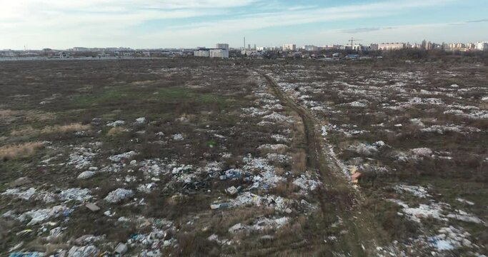 two people walking on a huge aste, garbade, dump, rubbish landill in Bucharest
