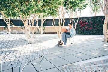 Student working with laptop and relaxing in the park.