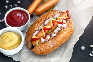 Hot Dog With Yellow Mustard, ketchup, Onion, Pickles and Tomatoes.