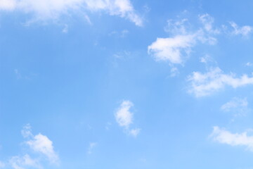 The sky with white clouds floated in the sky on a clear day. There is a light sunlight and a cool breeze blowing to feel refreshed. Relax like a groove floating in the sky
