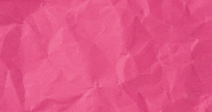 Wrinkled sheet of pink paper. Textured backdrop
