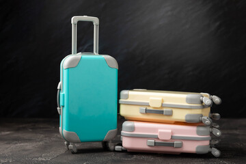 Travel.Vacation money saving concept,beach vacation.Miniature luggage and bundles of hundred dollar bills.Vacations.Copy space.Savings concept for vacation.