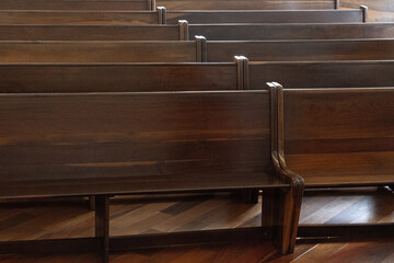 Empty side-by-side wooden pews in a church