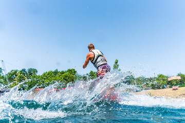 Splashing water because of a wakeboarder in background