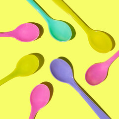 Pastel malted ice cream and spoons on light pastel pink background. Creative food concept. Minimalistic sweets composition. Sunny summer day idea.