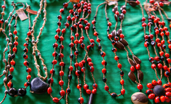 Organic handicrafts from the Amazon rainforest with huayruro seeds (Ormosia coccinea) necklaces, Yasuni national park, Ecuador.