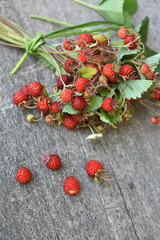 Wild strawberry on wooden background. Fragaria vesca