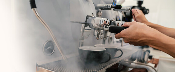 Close up hands of barista make coffee latte art with espresso machine in cafe vintage color...