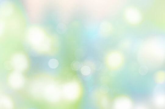 Spring blurred abstract background.Green blue glowing lights backdrop.
