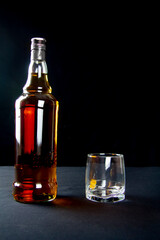 A strong amber whiskey on a black background. Scotch Whisky