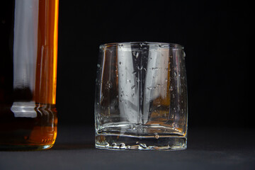 A strong amber whiskey on a black background. Scotch Whisky