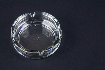 Glass ashtray for smoking a pipe. On a black background