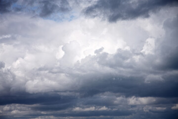 Weather background of storm clouds with hint of blue sky
