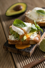 Breakfast concept - toast bread with sliced avocado, pouched egg