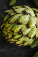 Fresh Artichoke on black background. Raw Artichok closeup