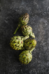 Fresh Artichoke on black background. Raw Artichok closeup