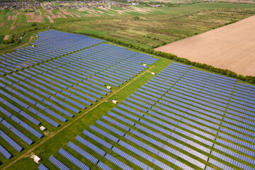 Aerial view of big sustainable electric power plant with many rows of solar photovoltaic panels for producing clean ecological electrical energy. Renewable electricity with zero emission concept