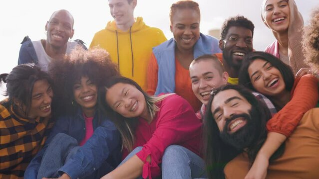 Multiracial friends having fun outdoor at sunset during summer vacations