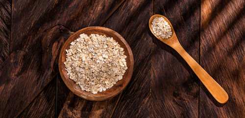 Avena sativa - Oat flakes in the wooden bowl