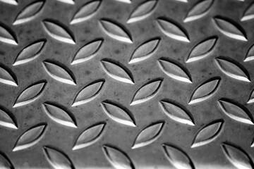 Solid diamond metal plate surface shows stainless steel flooring in industrial manufactury as...