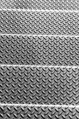 Solid diamond metal plate surface shows stainless steel flooring in industrial manufactury as steampunk background for metal stairs and heavy steel plates for protection and heavy armour army vehicles