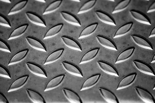 Solid diamond metal plate surface shows stainless steel flooring in industrial manufactury as steampunk background for metal stairs and heavy steel plates for protection and heavy armour army vehicles