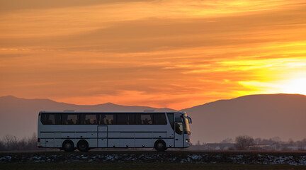 Intercity passenger bus driving on highway road in evening © bilanol