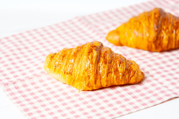 Freshly baked croissants on a cotton napkin.
