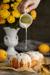 Cinnabon Rolls with blueberries and cream poured on a great background with flowers on the table