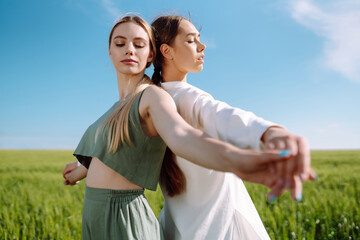Two fashion woman in the green field. Freedom travel. Summer landscape.